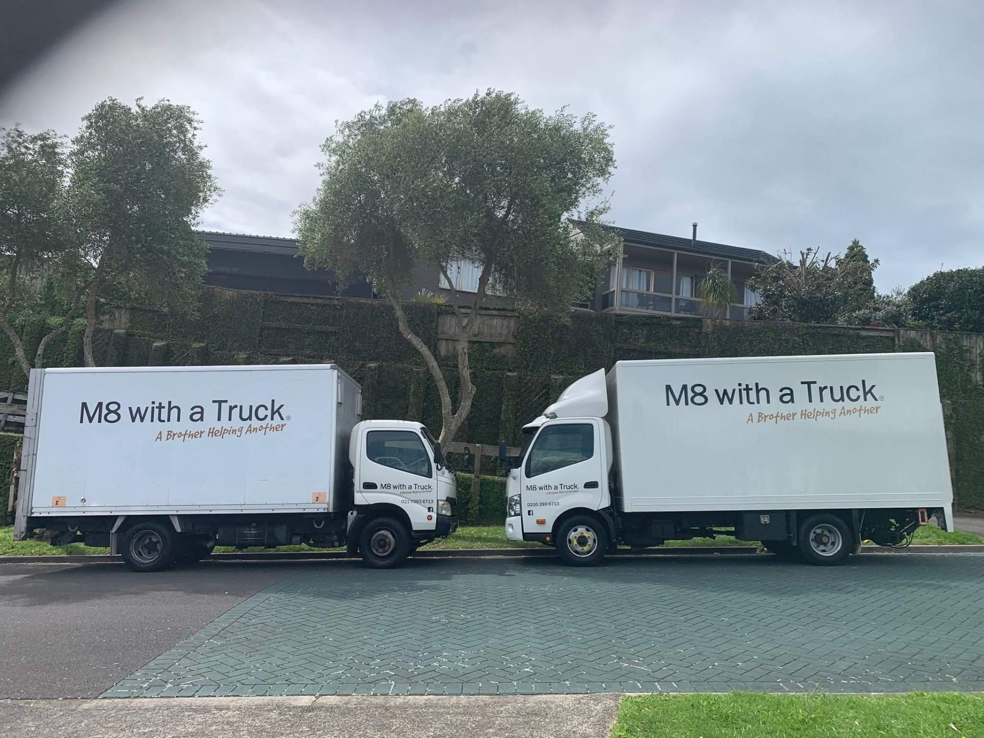 Two trucks parked up between jobs in the Bay of Plenty.